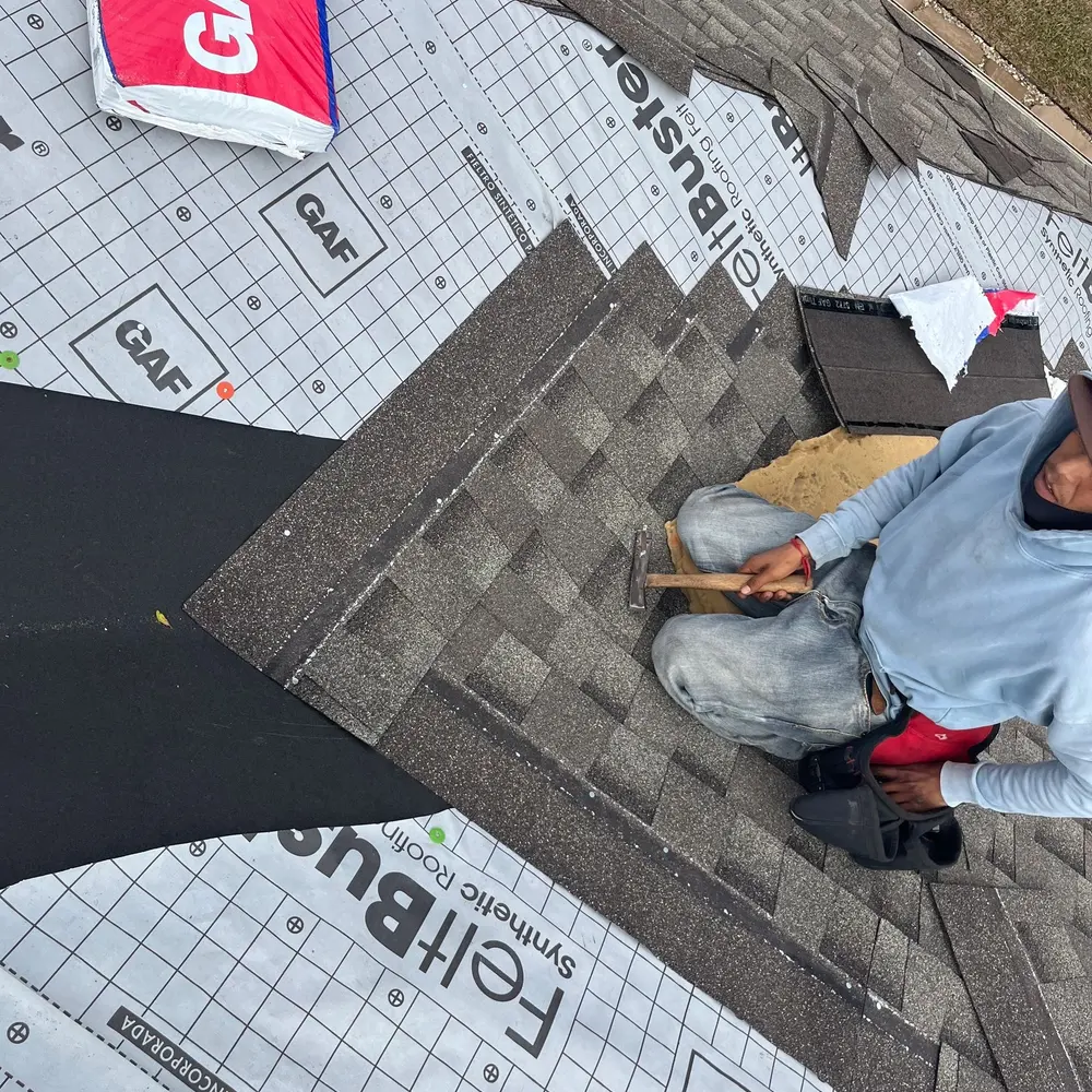 RoofPro roofing work in progress, with shingles being installed over roof underlayment